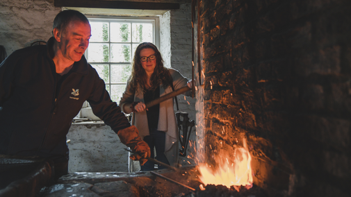 Blacksmith demonstration in the Forge at Florence Court, County Fermanagh, Northern Ireland.
